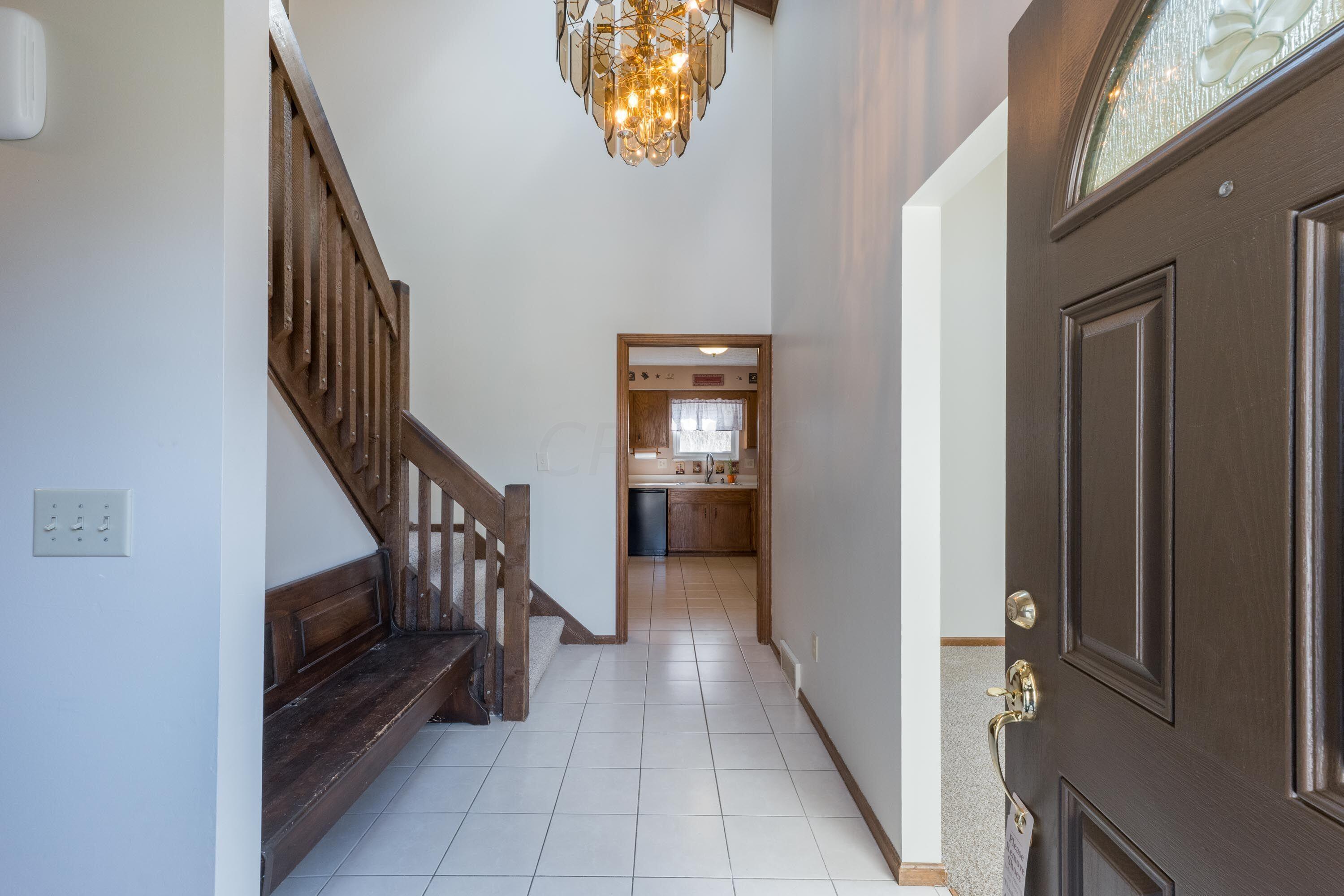 7826 Strathmoore Road Dublin, OH 43016 - Photo 5 of 47 Front Door to Large Open Two-Story Foyer with Chandlier.