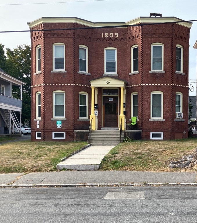 a view of a yard in front of a brick house