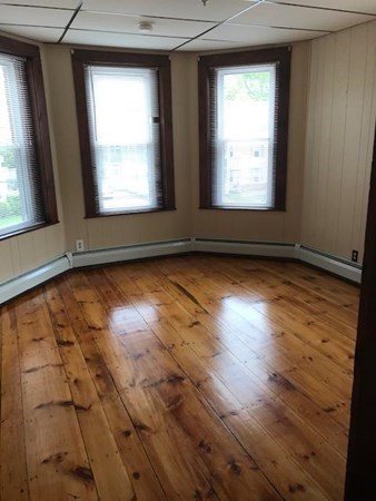 100 4th Avenue Lowell, MA 01854 - Photo 9 of 12 an empty room with wooden floor and windows