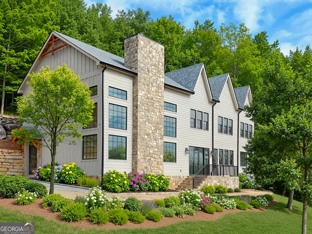 a front view of a house with a yard and potted plants