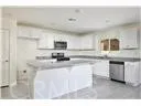 a kitchen with kitchen island a sink stainless steel appliances and cabinets