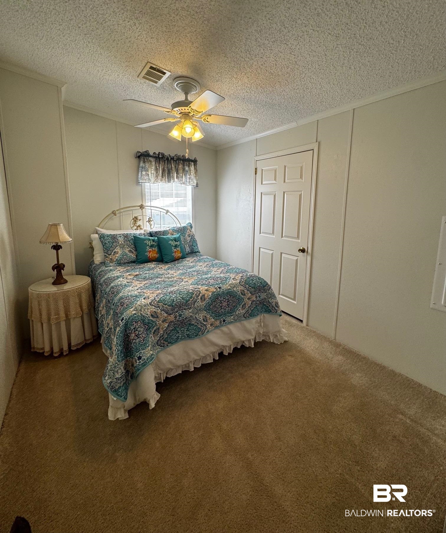 1351 Caney Loop Lillian, AL 36549 - Photo 12 of 35 Carpeted bedroom featuring a textured ceiling, a ceiling fan, and crown molding