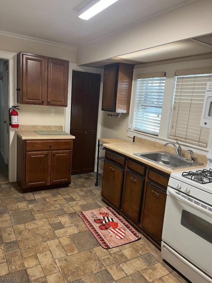 136 East Main Street, Unit 1 Little Falls, NJ 07424 - Photo 8 of 11 a kitchen with stainless steel appliances granite countertop a stove a sink dishwasher and a refrigerator