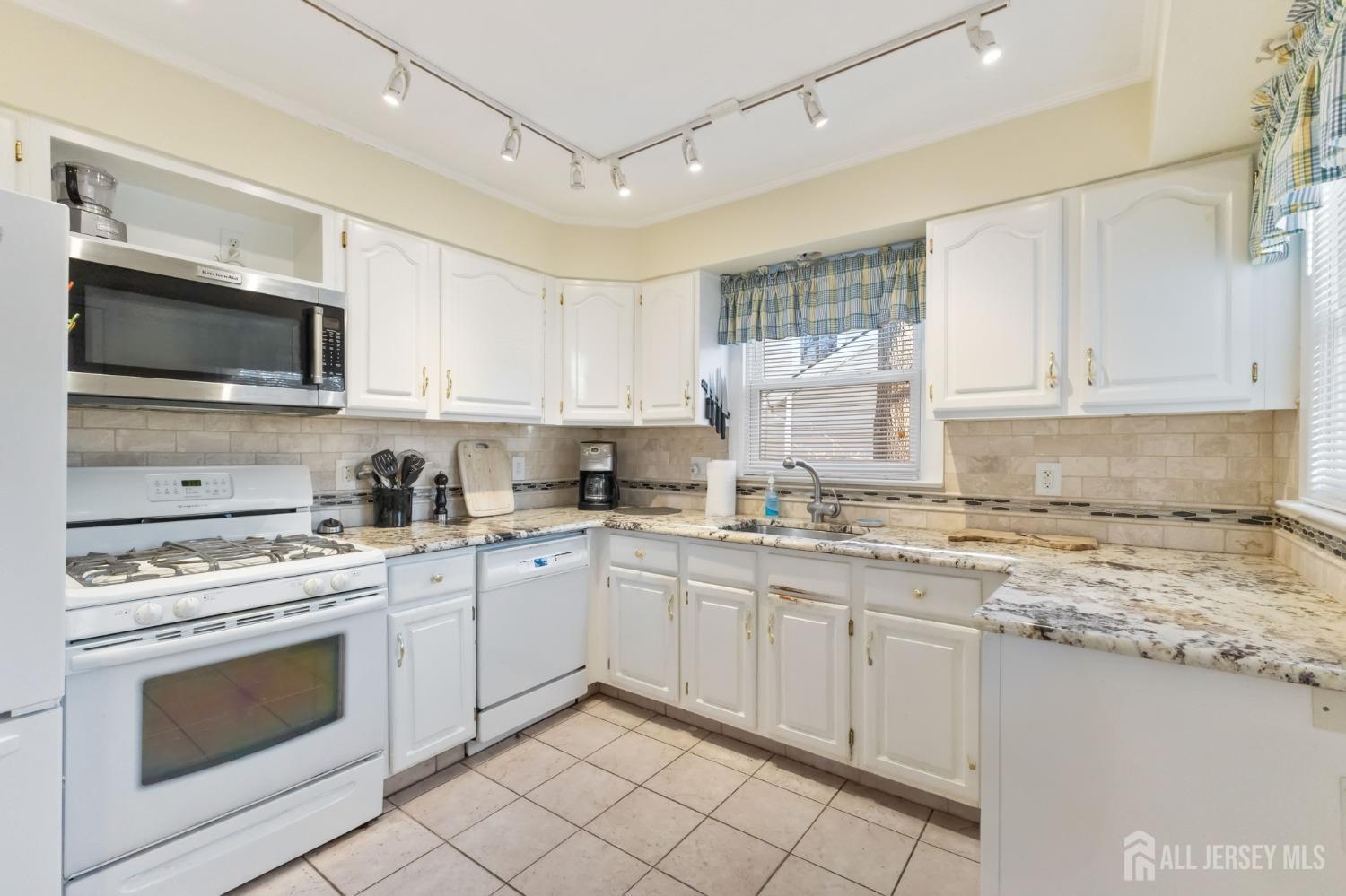60 Edwards Road Brick, NJ 08723 - Photo 27 of 49 a kitchen with cabinets stainless steel appliances and a sink