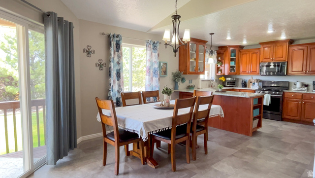 1797 Sunset Road Enoch, UT 84721 - Photo 8 of 80 Open-concept dining area featuring a sliding glass door leading to an outdoor deck