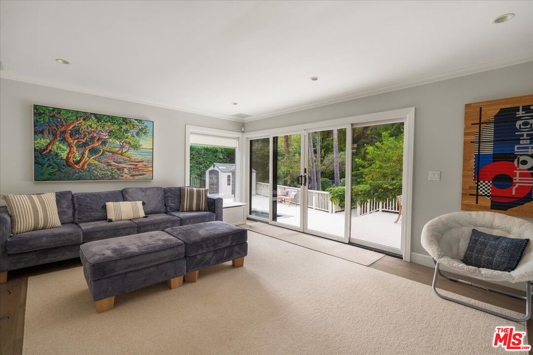 3479 Mandeville Canyon Road Los Angeles, CA 90049 - Photo 12 of 55 a living room with furniture and a large window