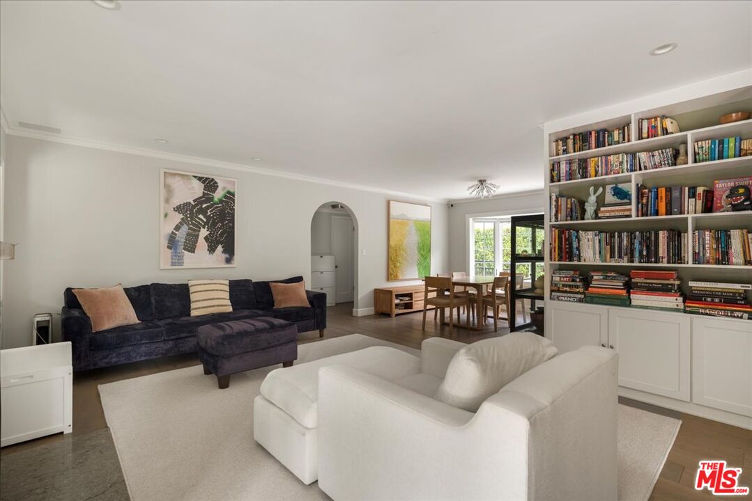 3479 Mandeville Canyon Road Los Angeles, CA 90049 - Photo 13 of 55 a living room with furniture and a book shelf