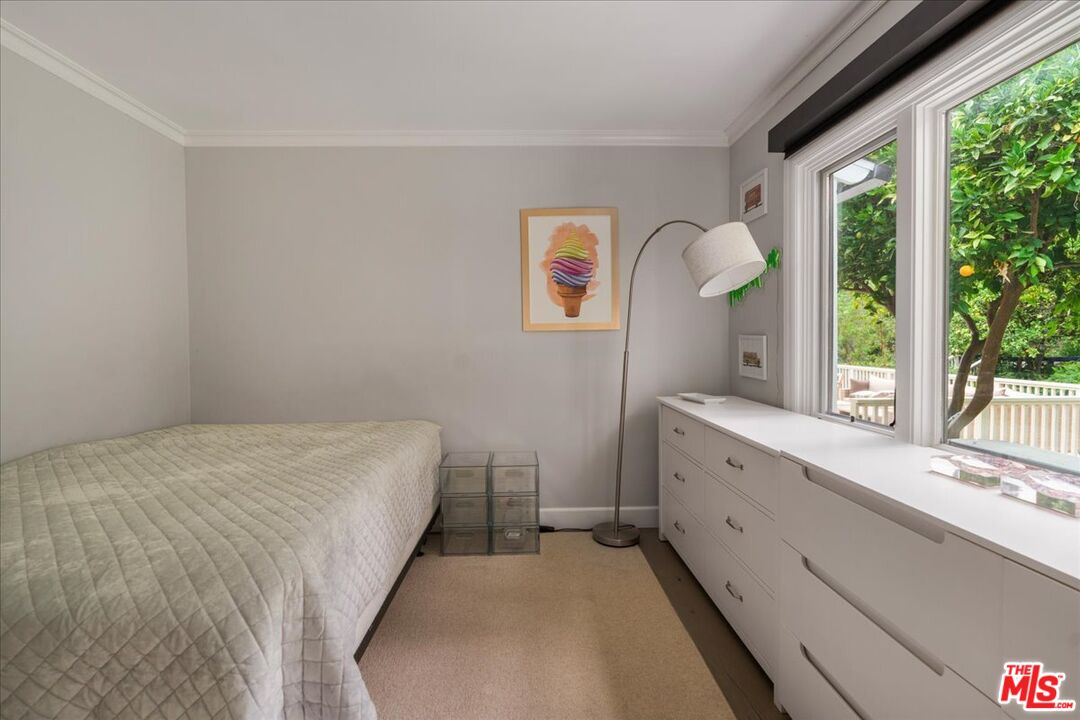 3479 Mandeville Canyon Road Los Angeles, CA 90049 - Photo 17 of 55 a bedroom with a bed and a large window