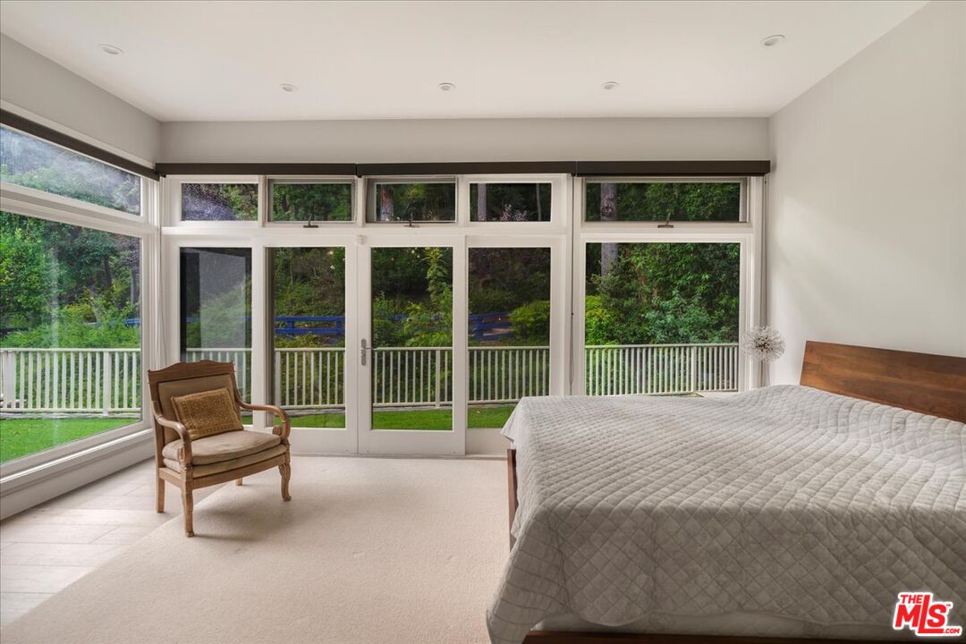3479 Mandeville Canyon Road Los Angeles, CA 90049 - Photo 24 of 55 a bedroom with a bed and a large window