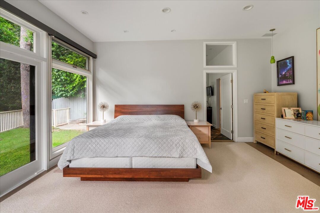 3479 Mandeville Canyon Road Los Angeles, CA 90049 - Photo 26 of 55 a bedroom with a bed and a large window