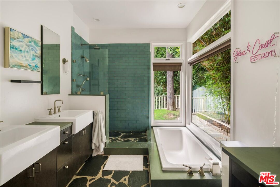 3479 Mandeville Canyon Road Los Angeles, CA 90049 - Photo 28 of 55 a bathroom with a sink mirror and a bathtub