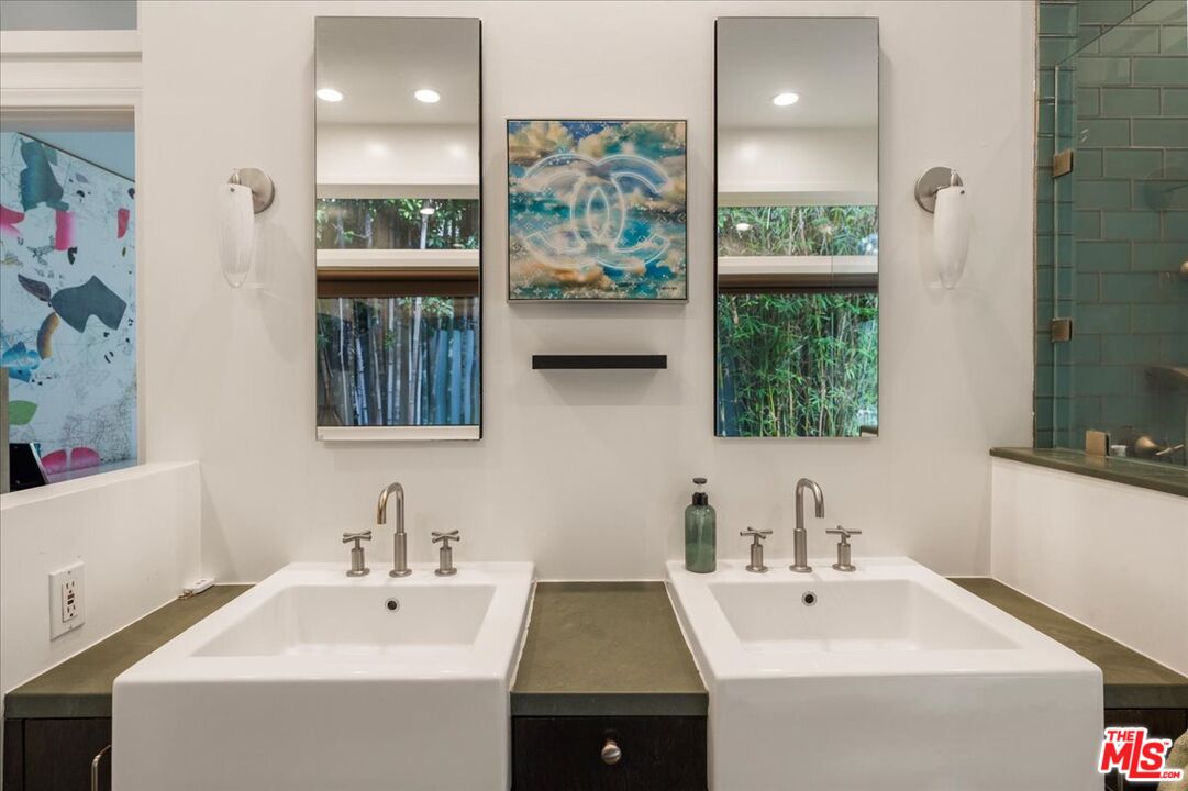 3479 Mandeville Canyon Road Los Angeles, CA 90049 - Photo 30 of 55 a bathroom with a sink and a mirror