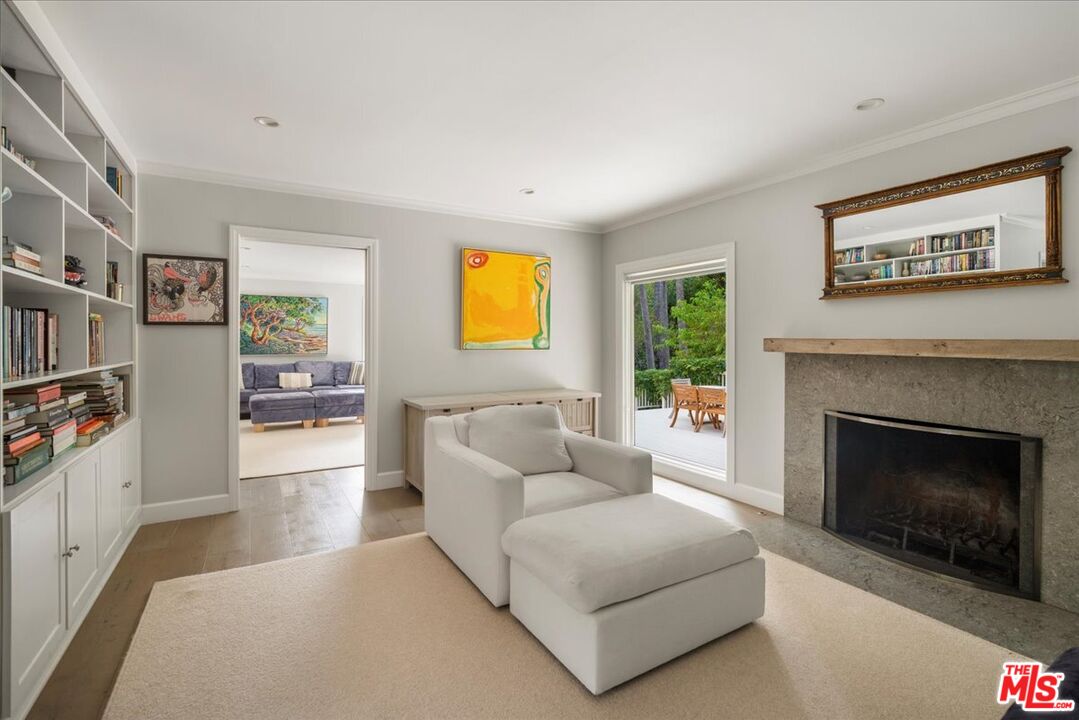 3479 Mandeville Canyon Road Los Angeles, CA 90049 - Photo 3 of 55 a living room with furniture and a fireplace