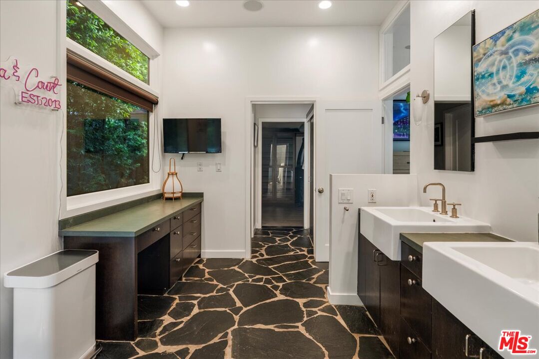 3479 Mandeville Canyon Road Los Angeles, CA 90049 - Photo 33 of 55 a bathroom with a sink and a mirror