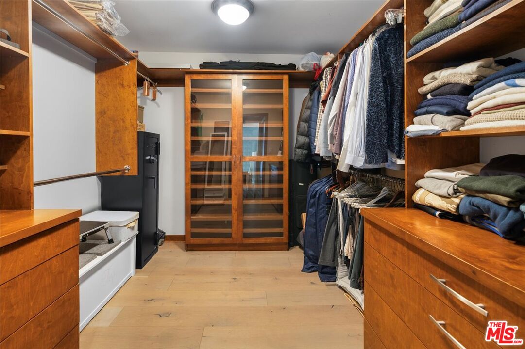 3479 Mandeville Canyon Road Los Angeles, CA 90049 - Photo 34 of 55 a view of walk in closet with clothes and shoes