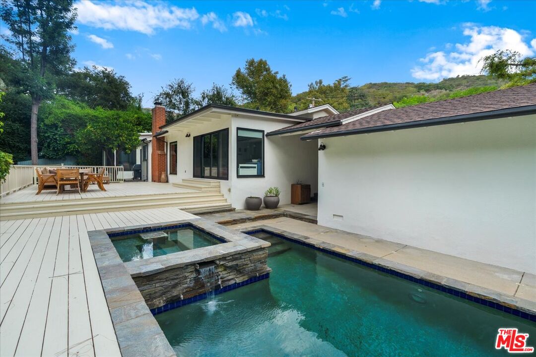 3479 Mandeville Canyon Road Los Angeles, CA 90049 - Photo 35 of 55 a view of a swimming pool with a patio
