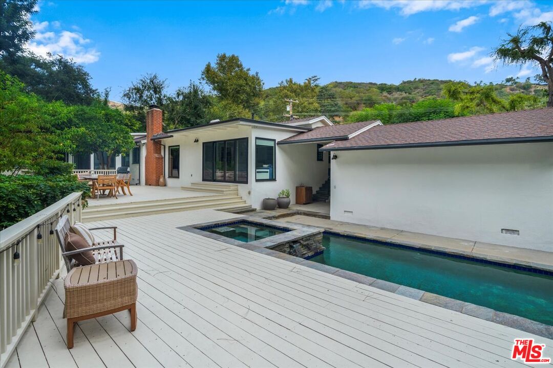 3479 Mandeville Canyon Road Los Angeles, CA 90049 - Photo 37 of 55 a front view of a house with garden