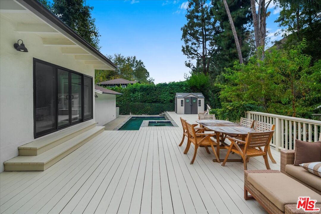 3479 Mandeville Canyon Road Los Angeles, CA 90049 - Photo 41 of 55 a view of a chairs and table on the wooden floor