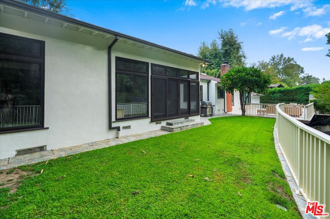 3479 Mandeville Canyon Road Los Angeles, CA 90049 - Photo 44 of 55 a view of house with backyard and a slide