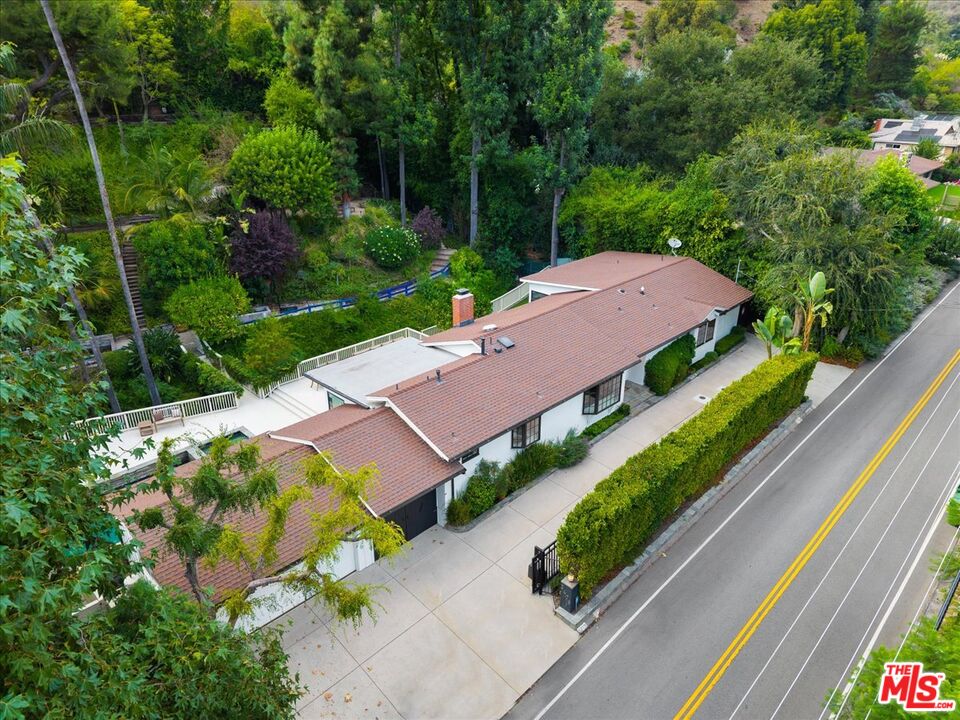 3479 Mandeville Canyon Road Los Angeles, CA 90049 - Photo 51 of 55 an aerial view of a house with a garden and plants
