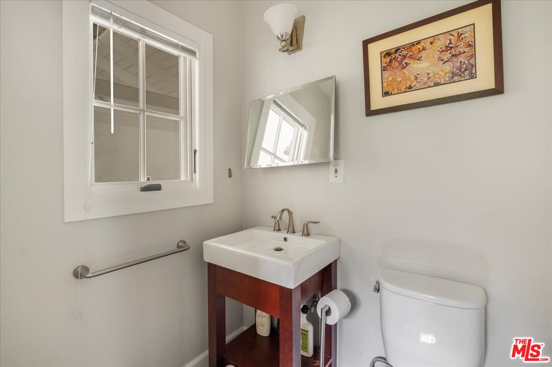 3479 Mandeville Canyon Road Los Angeles, CA 90049 - Photo 9 of 55 a bathroom with a sink and a mirror