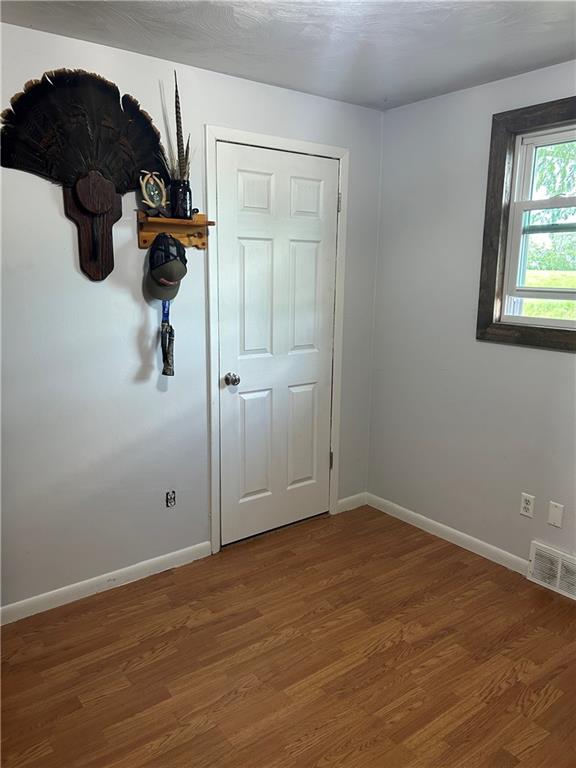 114 Howes Run Road Sarver, PA 16055 - Photo 26 of 33 an empty room with wooden floor cabinet and windows