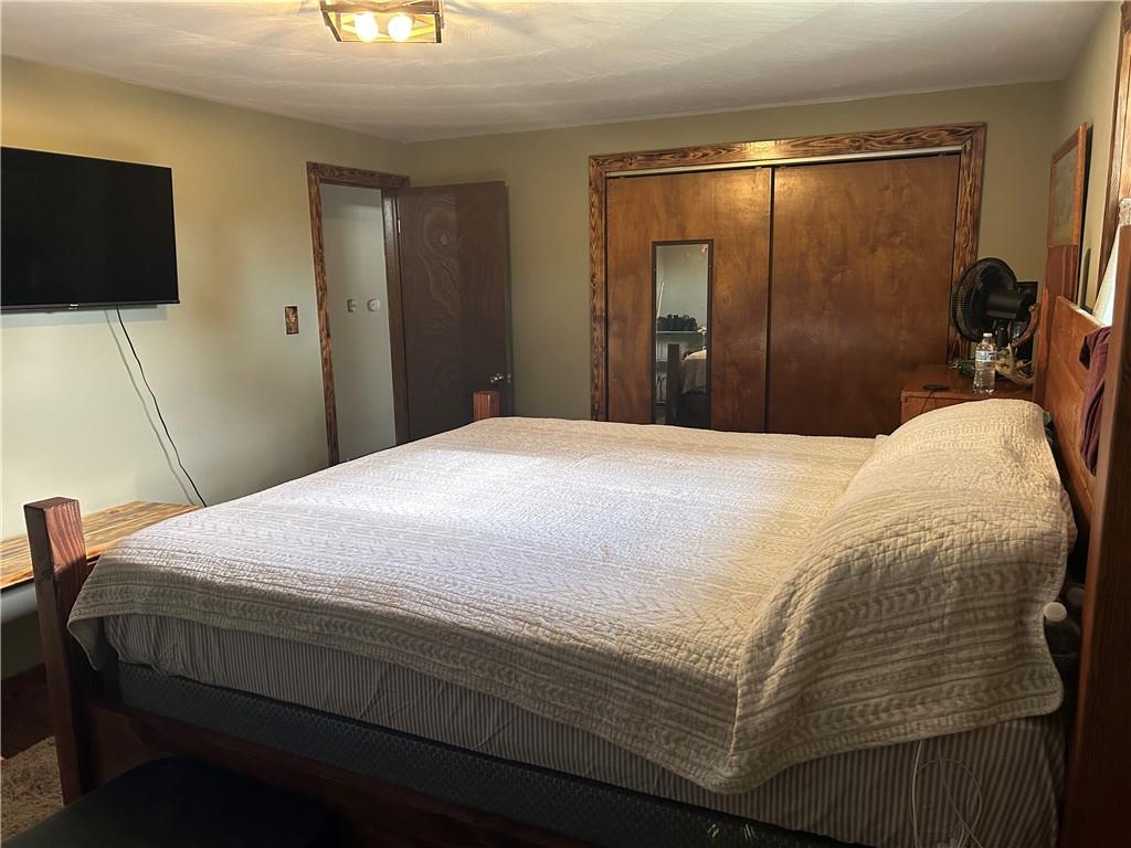 114 Howes Run Road Sarver, PA 16055 - Photo 27 of 33 a bedroom with a bed and a flat tv screen on wall
