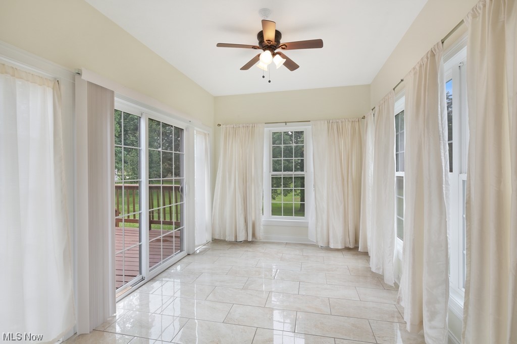 25600 Tryon Road Bedford, OH 44146 - Photo 16 of 34 Light-filled Sunroom with wall of windows and door leading to the large deck