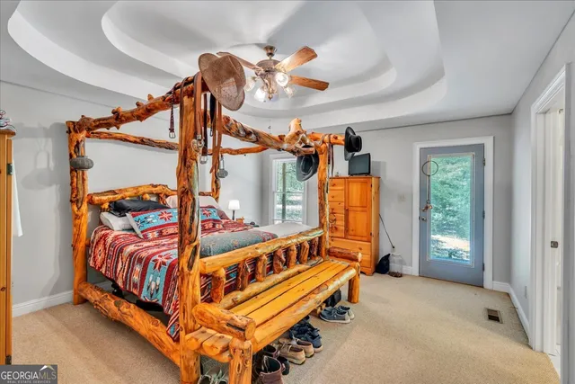a view of a bedroom with furniture and window