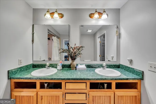 a bathroom with a sink double vanity and a mirror