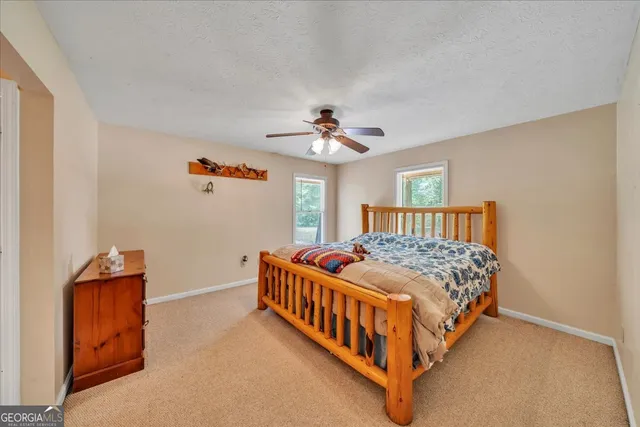 a bathroom with a toilet and a shower curtain