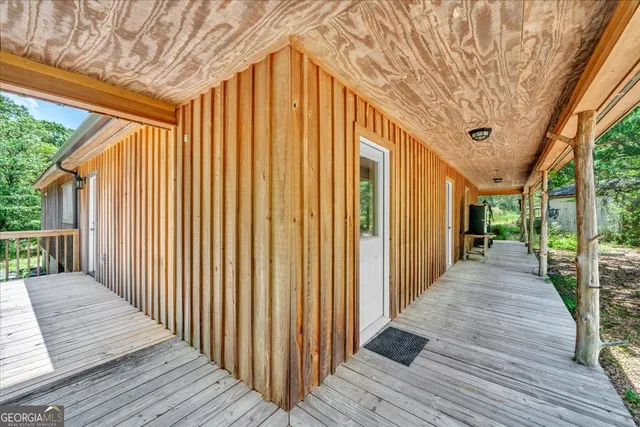 a view of a lake with a yard and large trees