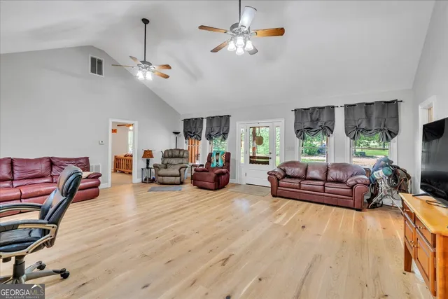 a living room with furniture a fireplace and a window