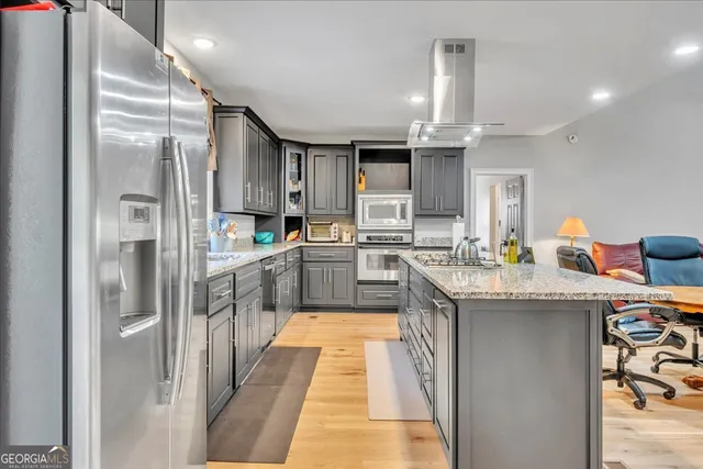 a kitchen with stainless steel appliances granite countertop a sink stove and refrigerator