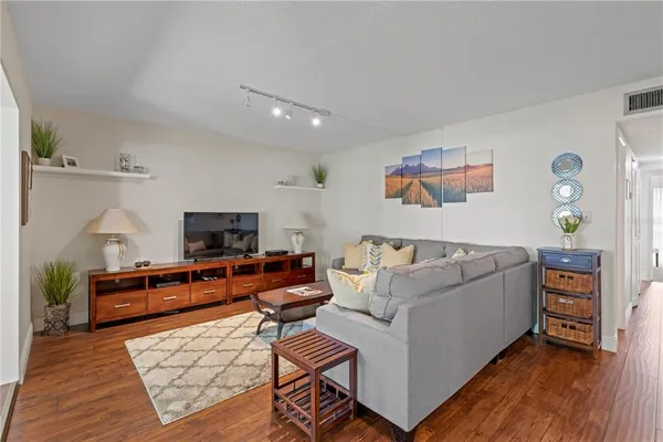 a kitchen with stainless steel appliances granite countertop white cabinets a sink a stove a refrigerator and white cabinets