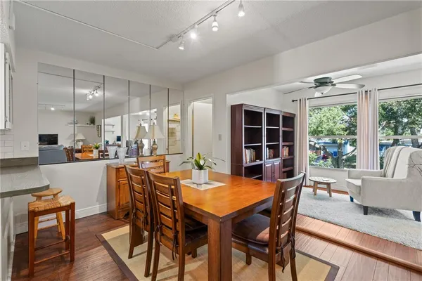 a living room with furniture hardwood floor and a large window
