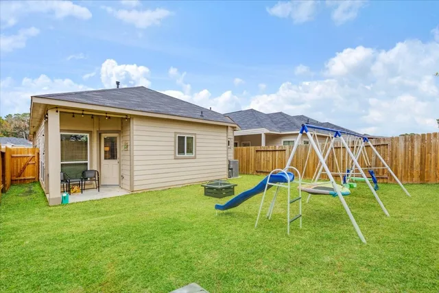 a backyard of a house with table and chairs