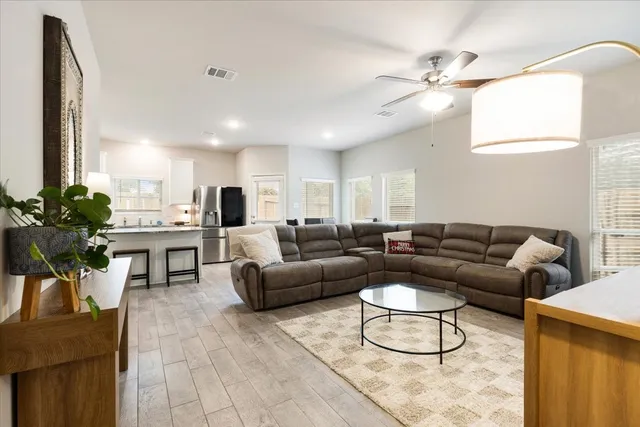 a living room with furniture and kitchen view