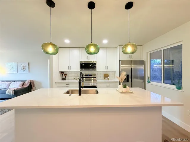 a kitchen with a counter space a sink and cabinets