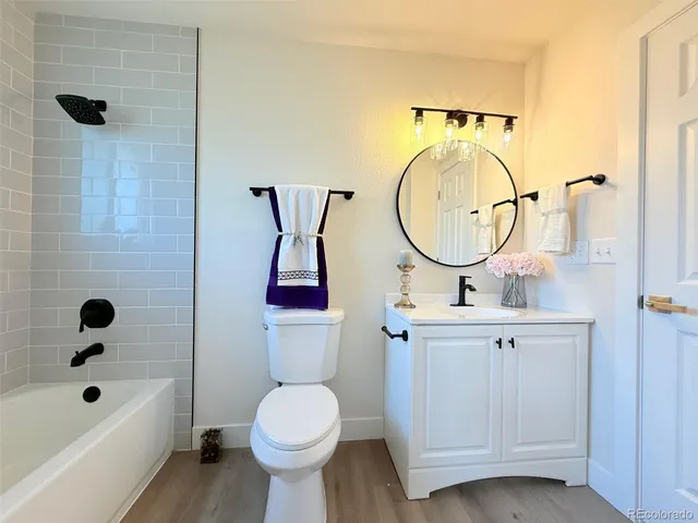 a bathroom with a sink a toilet and bathtub