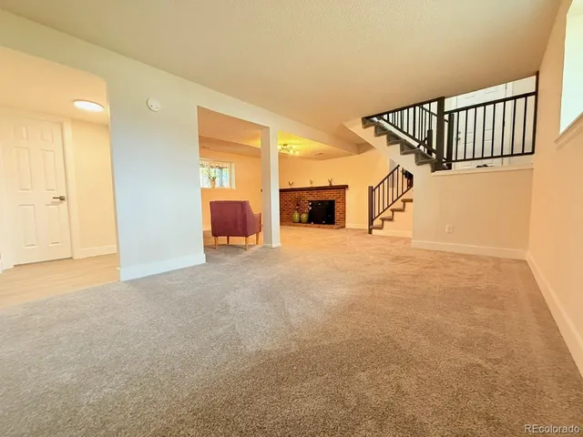 a living room with furniture and stairs