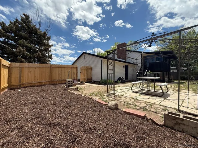 a view of a backyard with sitting area