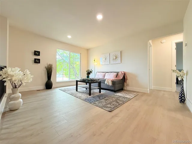 a living room with furniture and wooden floor