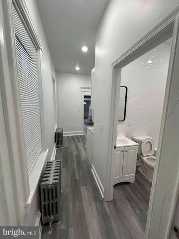 a view of hallway with wooden floor