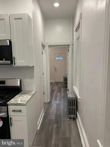a view of a kitchen from the hallway