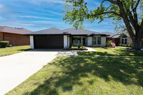a house view with a sitting space and garden