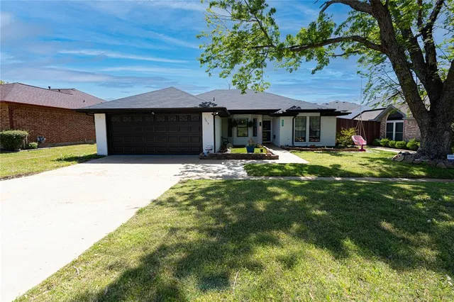 a house view with a sitting space and garden