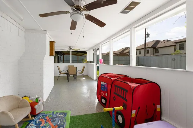 a living room with furniture a rug and ceiling fan