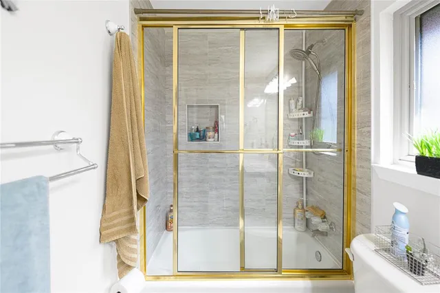 a bathroom with a glass shower door
