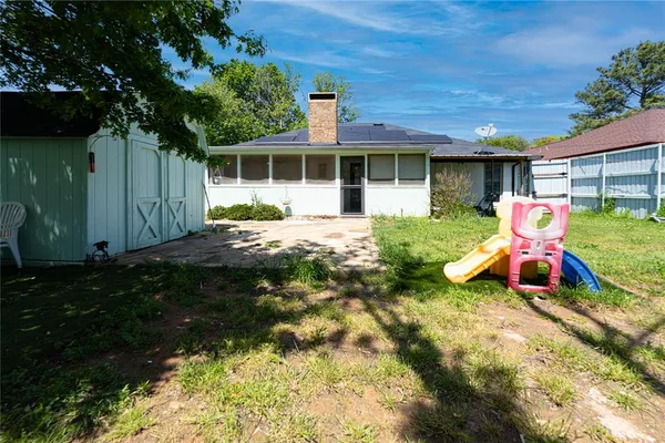 a front view of a house with a yard patio and fire pit